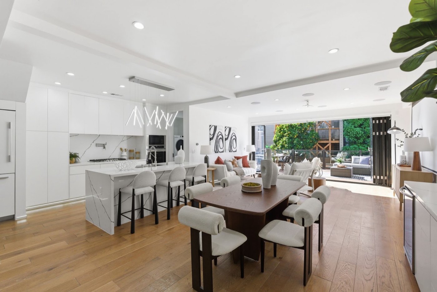 Open-plan remodeled kitchen and dining opening to a deck